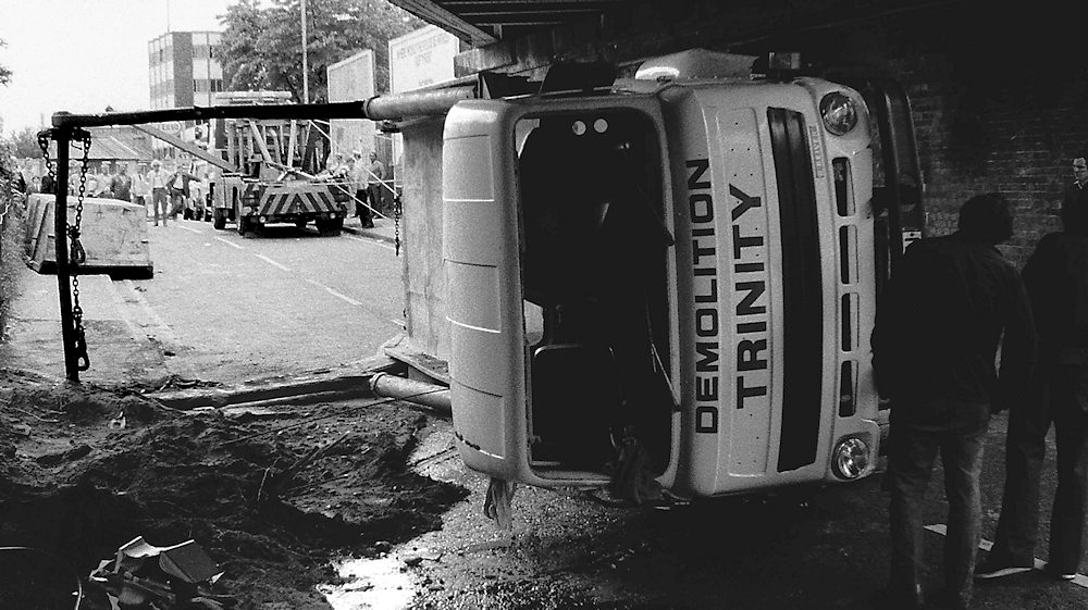 A skip Lorry on its side after hitting a bridge in Kingston Surrey